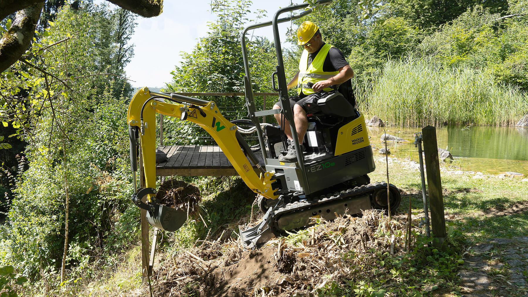 excavator in action in landscaping